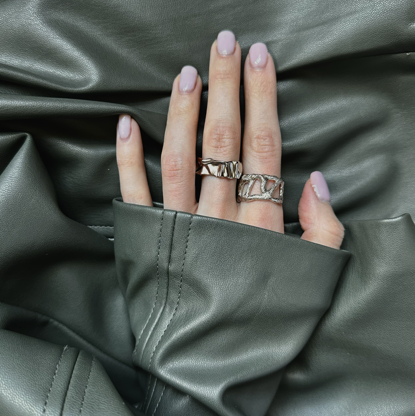 Silver rings on a female hand, nail polish